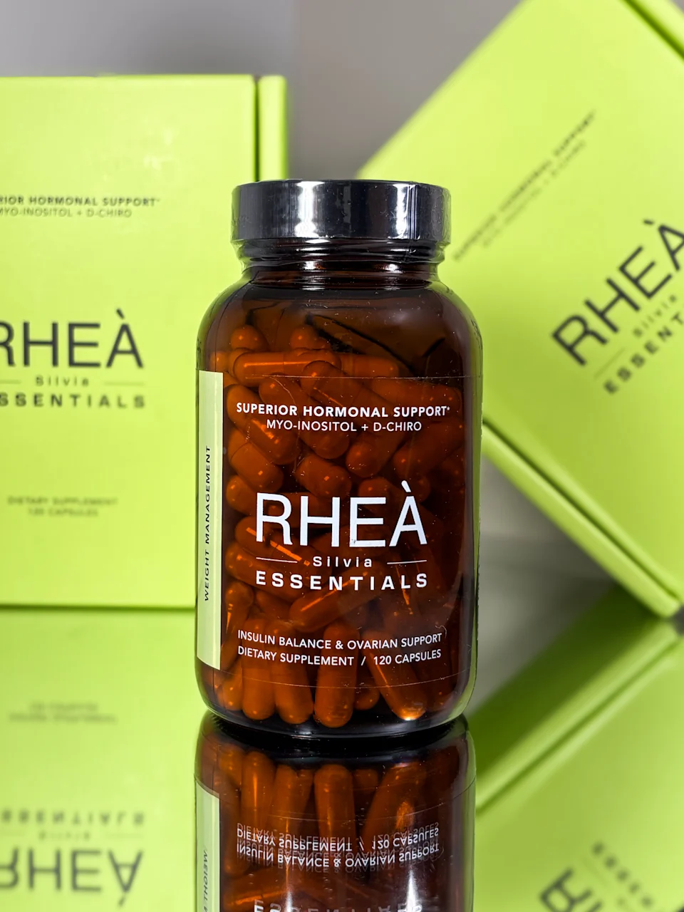 Amber glass supplement bottles styled on cream linen with eucalyptus